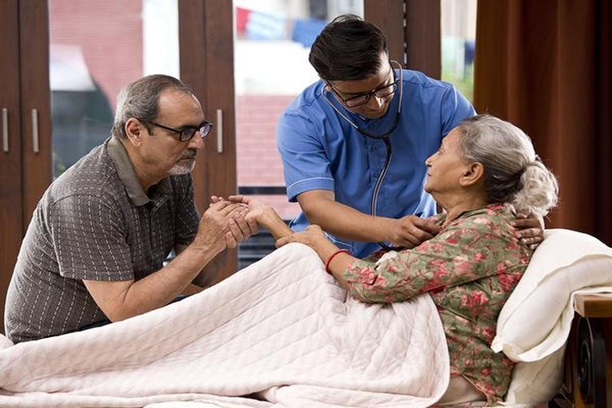 Elderly parents receiving daily care and support.