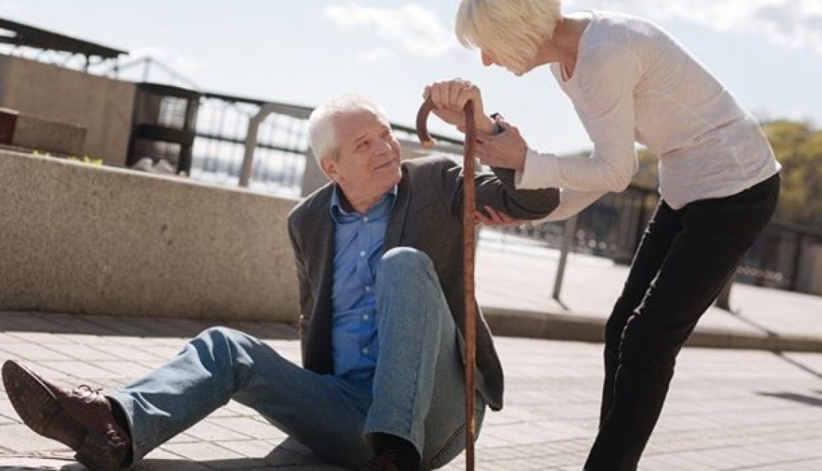 Senior wearing smartwatch with fall detection for fall prevention.