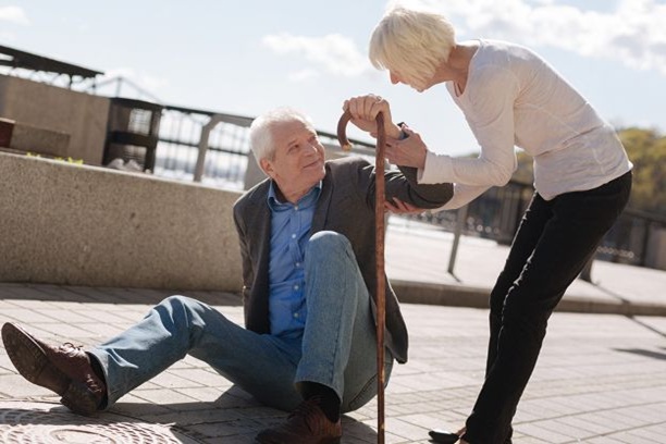 Senior wearing smartwatch with fall detection for fall prevention.
