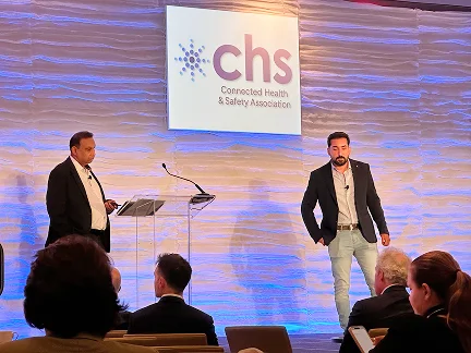 Speakers on stage at the CHS Annual Conference beside the Connected Health and Safety Association sign