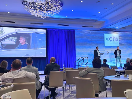 Audience seated at the CHS Annual Conference watching a vehicle presentation