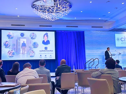 Audience watching a speaker profile on the conference screen
